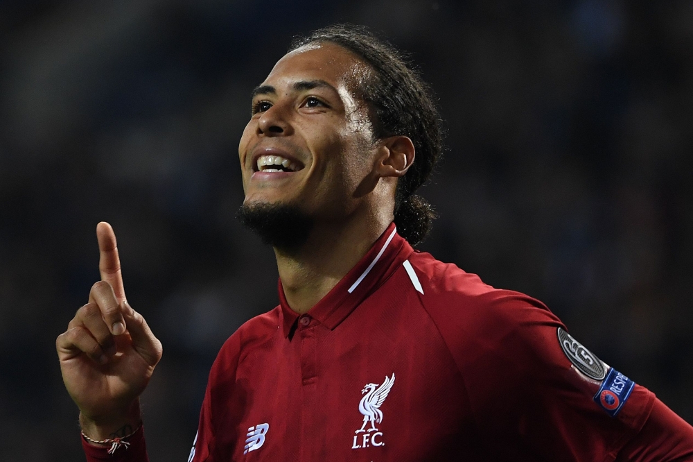 Liverpool's Dutch defender Virgil van Dijk celebrates after scoring his team's fourth goal during the UEFA Champions League quarter-final second leg football match between FC Porto and Liverpool at the Dragao Stadium in Porto on April 17, 2019. / AFP / Pa