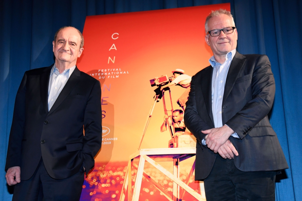 President of the Cannes Film Festival Pierre Lescure (L) and General Delegate of the Cannes Film Festival Thierry Fremaux pose in front of the Cannes offical poster during the presentation of the 72nd Cannes Film Festival Official Selection, in Paris on A