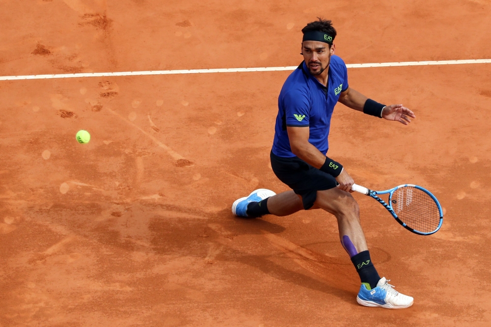 Italy's Fabio Fognini hits a return to Spain's Rafael Nadal during the semi final tennis match of the Monte-Carlo ATP Masters Series tournament in Monaco on April 20, 2019. / AFP / VALERY HACHE