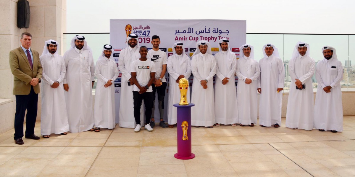 The officials of Qatar Football Association pose for a picture with the Emir Trophy during the Trophy Tour at Msheireb Properties yesterday.