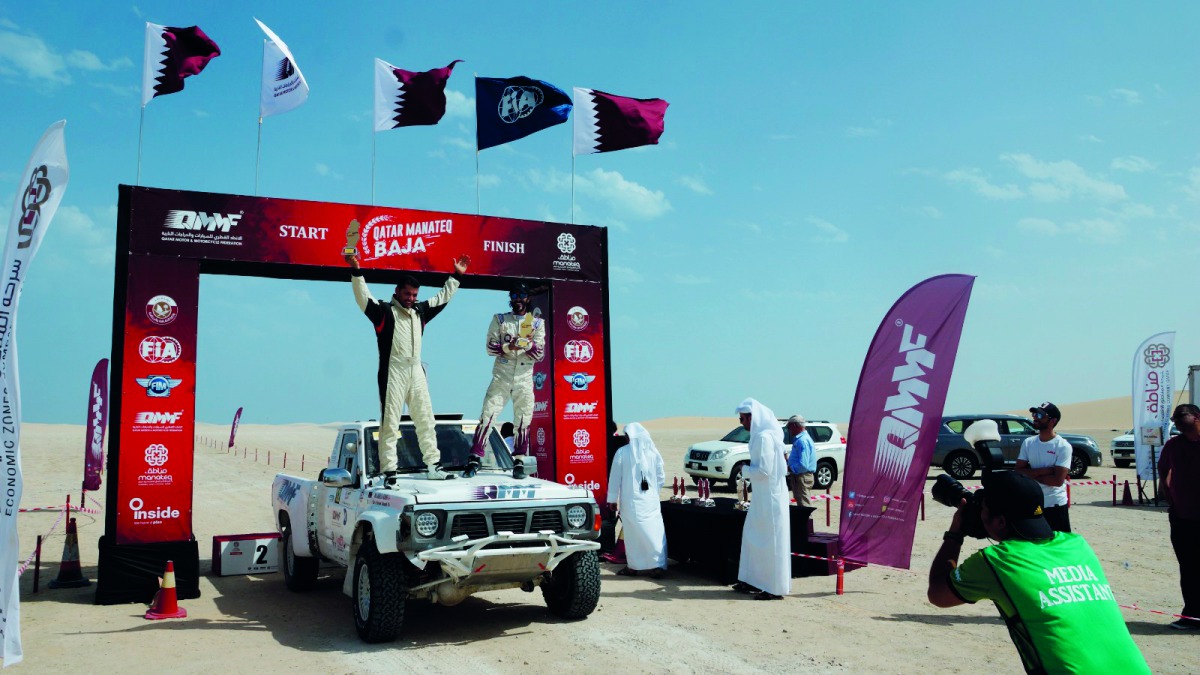 Qatari driver Jahman Jaralla and his co-driver Feras Allouh celebrate after winning Round 4 of the 2019 Qatar Manateq Baja, yesterday.