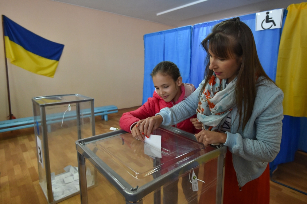 A woman casts her ballot at a polling station during the second round of Ukraine's presidential election in Kiev on April 21, 2019. / AFP / Genya SAVILOV 