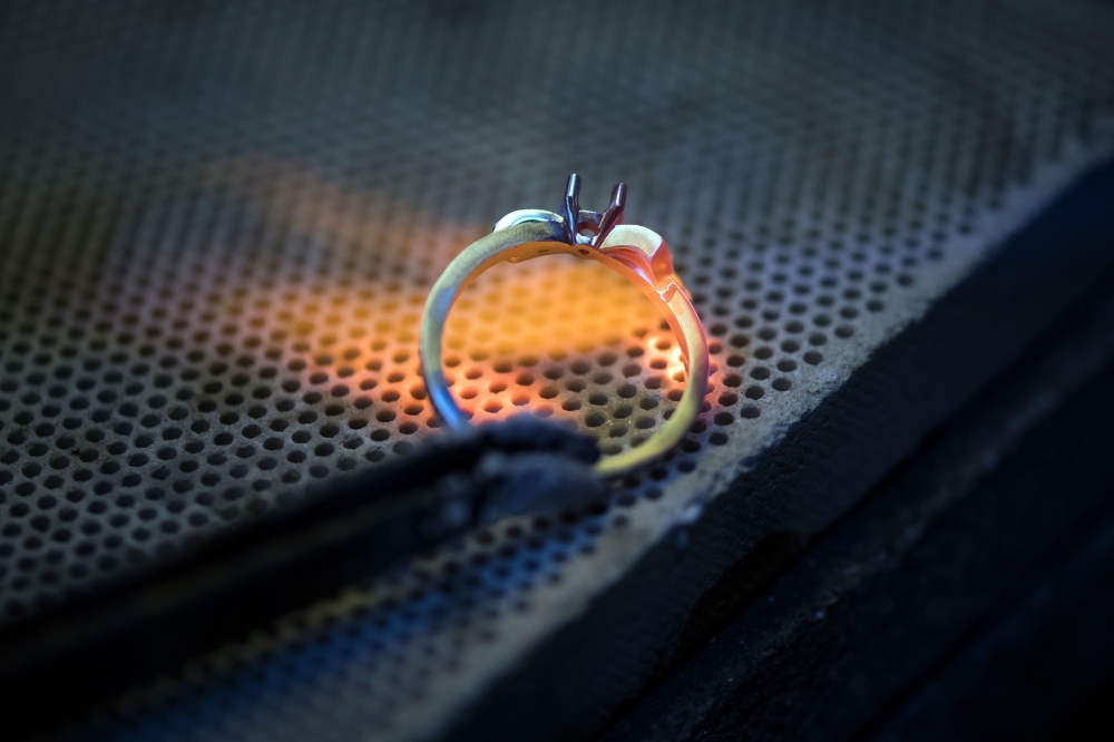 A jeweller works on a ring in an ethical gold jewellery workshop in Paris on February 18, 2019. AFP / Lionel Bonaventure 