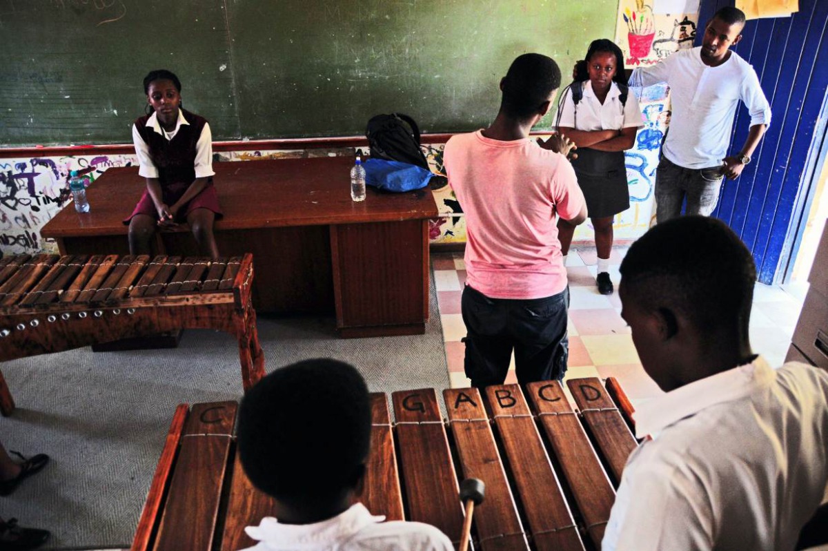 Sibusiso Nyamakazi speaks to his music students in a classroom in Philippi, Cape Town. Handout photo courtesy of Ross Jansen/AFD.