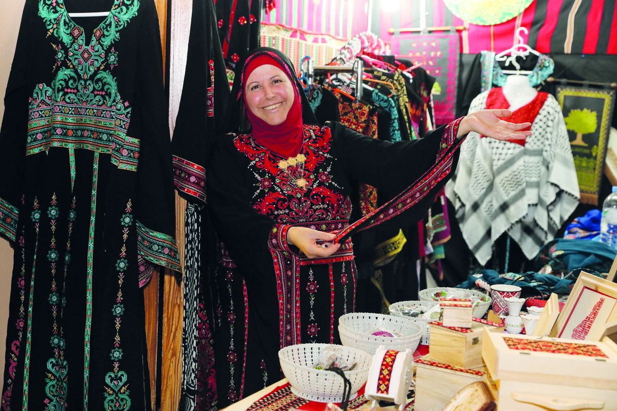 An artisan shows some of the handicraft in her stall at the traditional market at Palestine Cultural Festival.