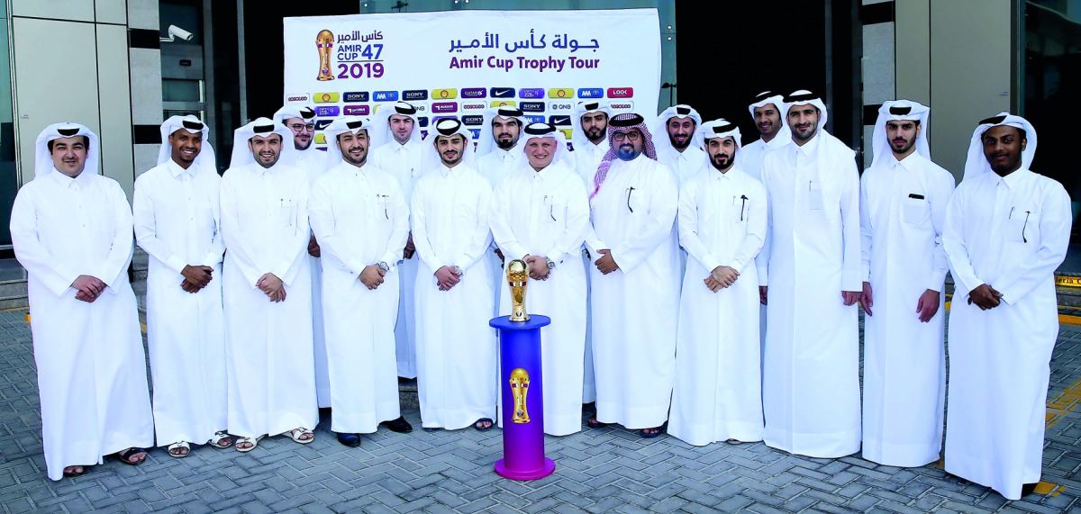 Qatar Airways officials pose for a group picture  with the Amir Cup during the Trophy Tour.