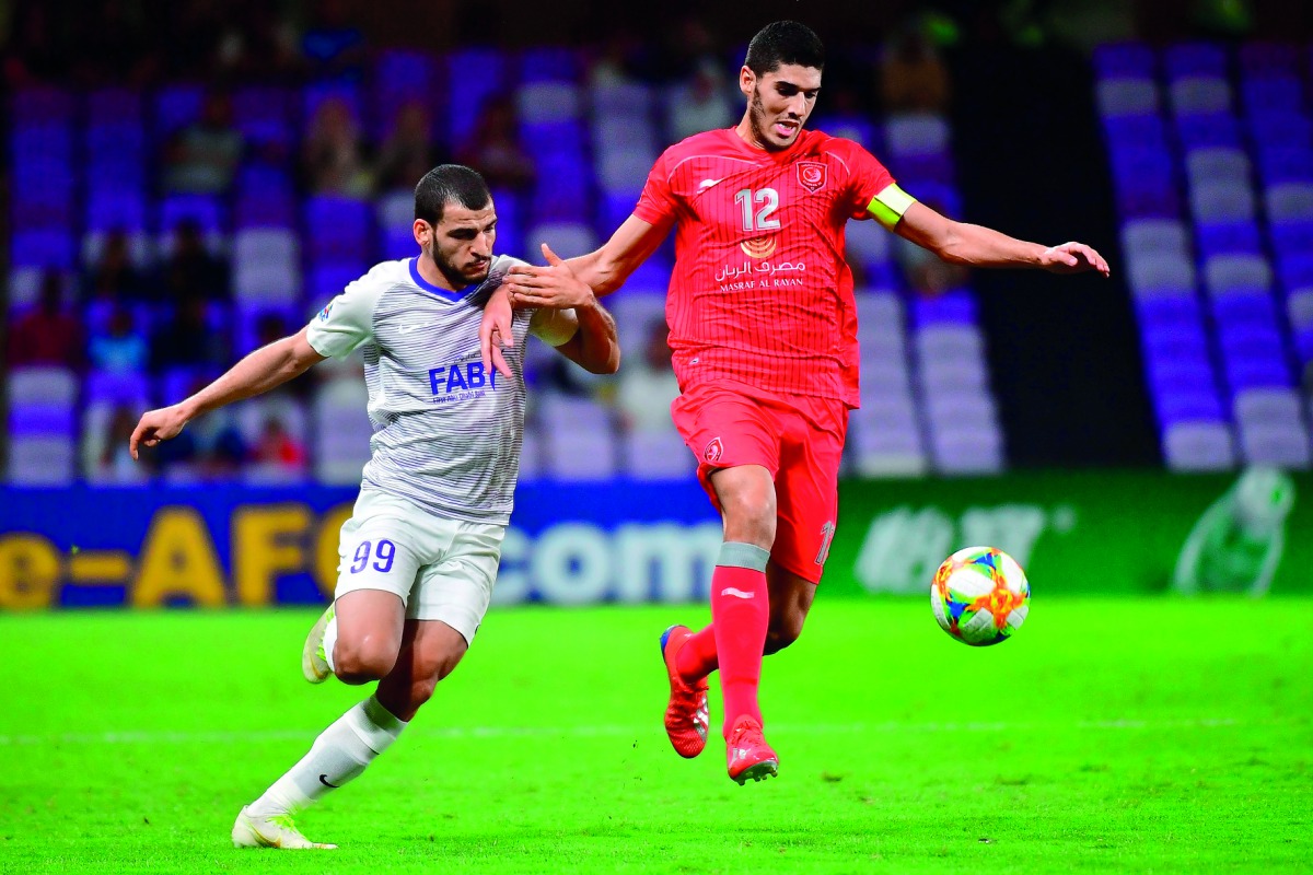 Al Duhail’s midfielder Karim Boudiaf (right) vies for the ball possession with Al Ain’s forward Jamal Ibrahim during their AFC Champions League group C match played at Hazza Bin Zayed Stadium in Al Ain, UAE, yesterday.