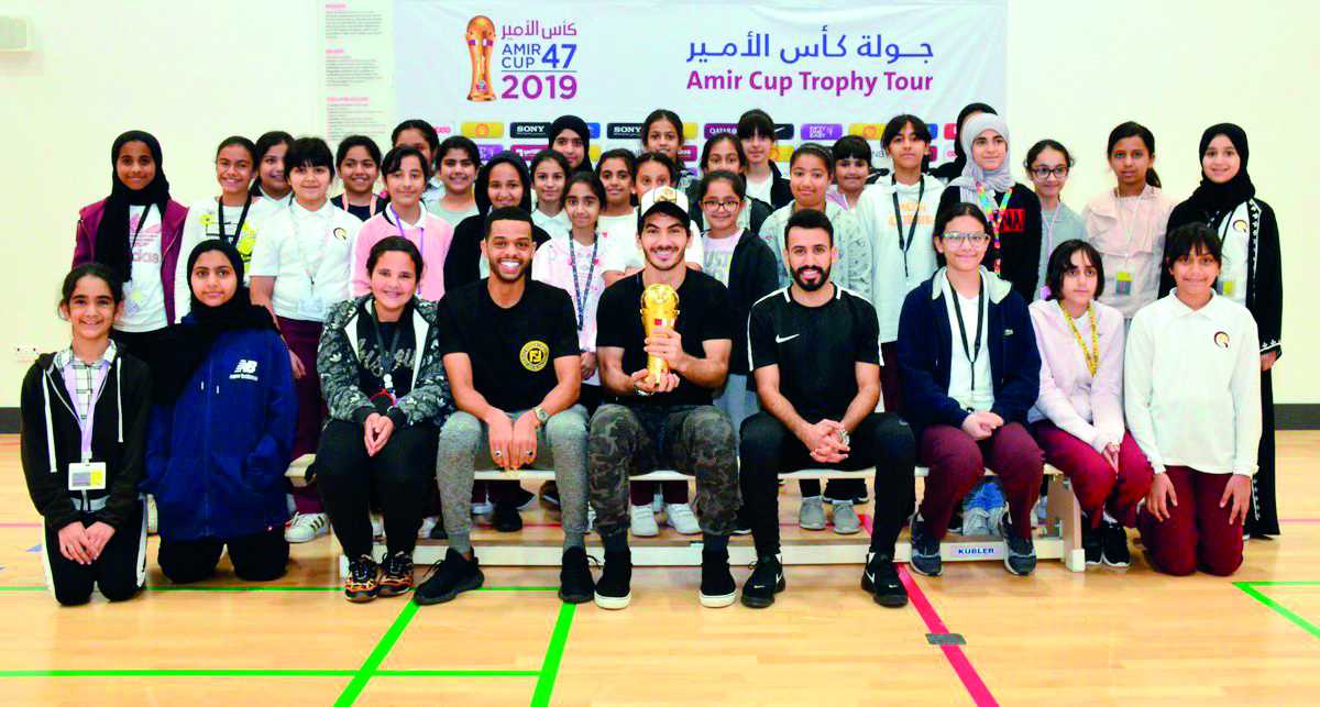 The school students pose for a picture with the Amir Cup during the Trophy Tour to Qatar  Academy Al Wakrah yesterday.