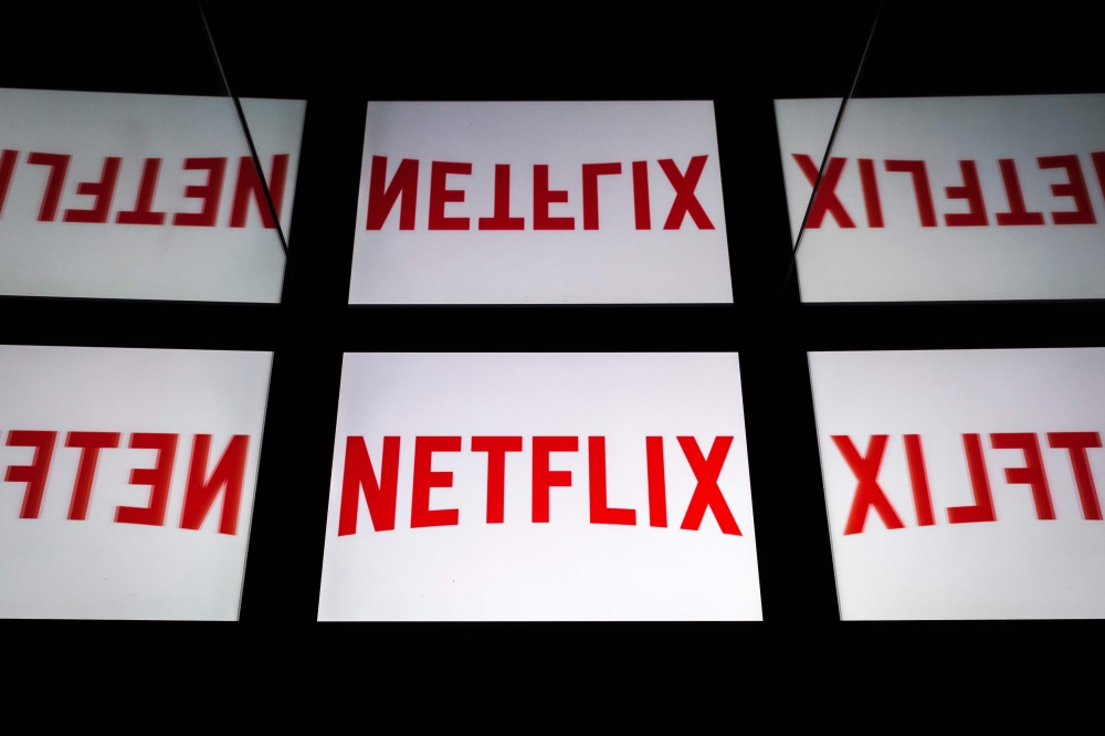 FILE PHOTO: This illustration picture shows the US Online Streaming giant Netflix logo displayed on a tablet in Paris.  AFP / Lionel BONAVENTURE