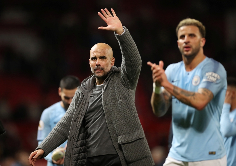 Manchester City manager Pep Guardiola and Manchester City's Kyle Walker after the match Action Images via Reuters/Carl Recine