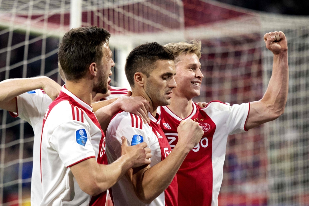 Dusan Tadic (C) of Ajax Amsterdam celebrates with teammates after scoring a goal during the Dutch Eredivisie football match Ajax Amsterdam vs Vitesse Arnhem at the Johan-Cruijff ArenA stadium in Amsterdam, on April 23 2019. - Netherlands OUT / AFP / ANP /