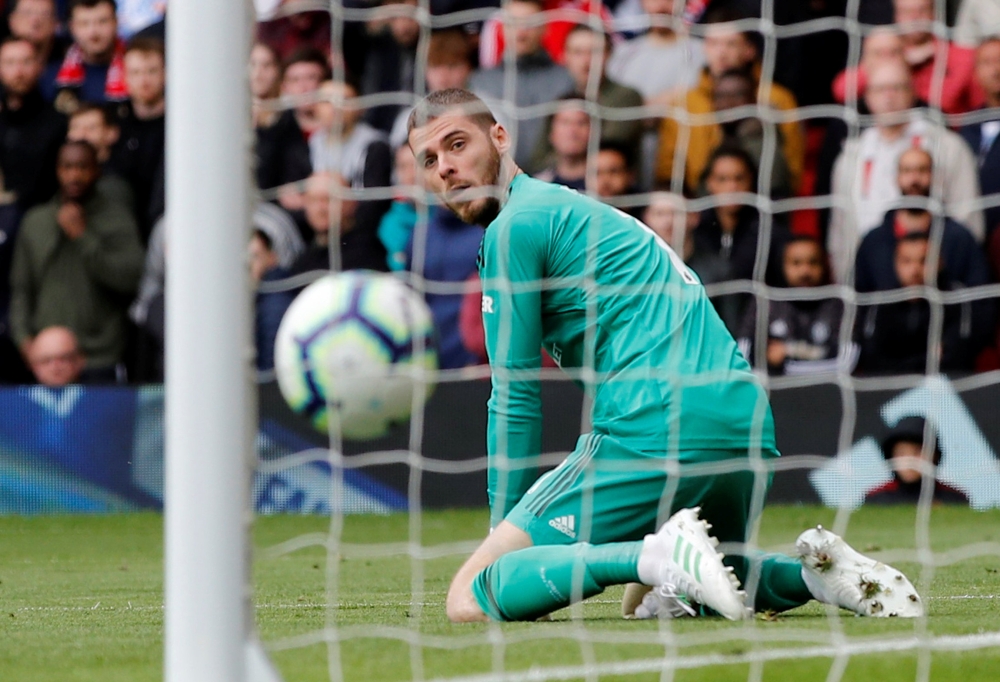 Chelsea's Marcos Alonso scores their first goal as Manchester United's David de Gea looks on REUTERS/Phil Noble 