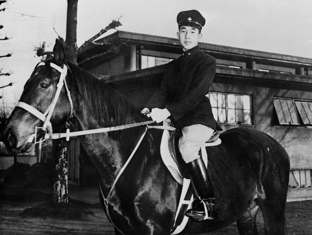 This file photo taken in the 50s shows Prince Akihito posing on horseback at an unknown location.  AFP