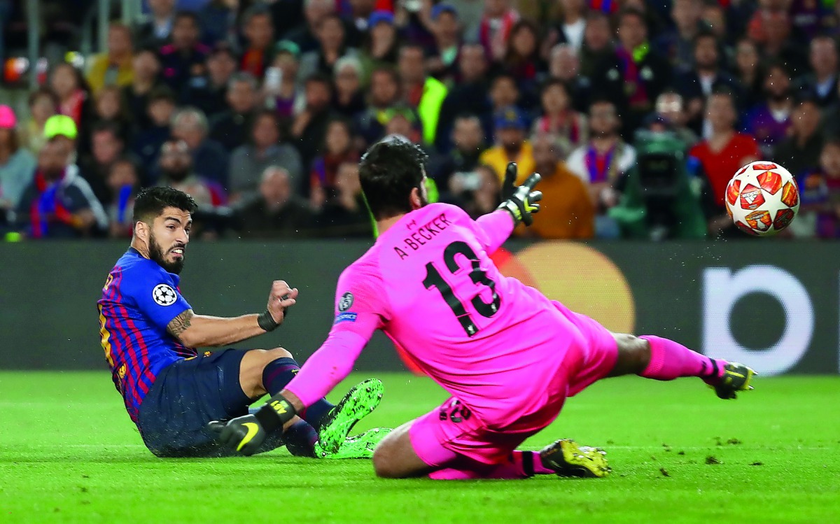 Barcelona’s Luis Suarez (left) scores their opening goal against Liverpool during the Champions League Semi-Final First Leg match played at the Camp Nou in Barcelona, Spain, yesterday. Reuters/Sergio Perez 