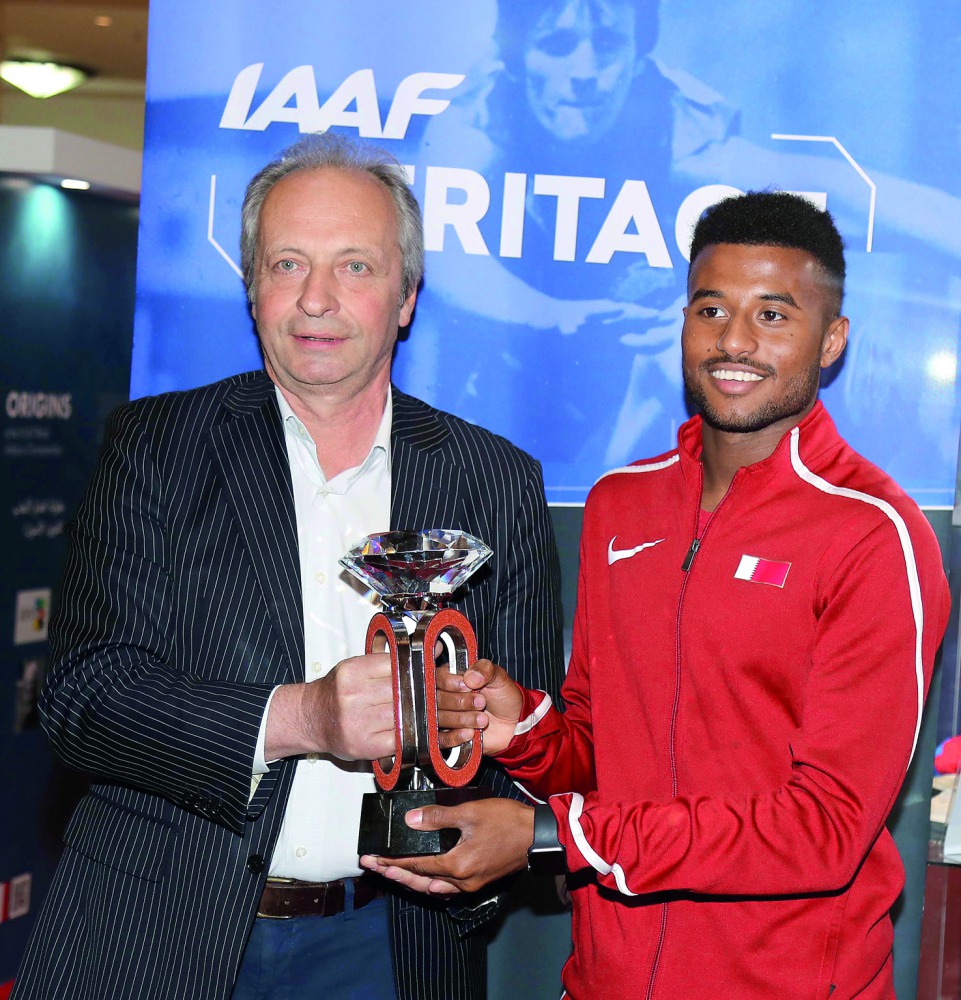 Diamond League CFO Petr Stastny and Qatar’s Youth Olympics Champion Owaab Barrow pose for a photograph with the Diamond Trophy.