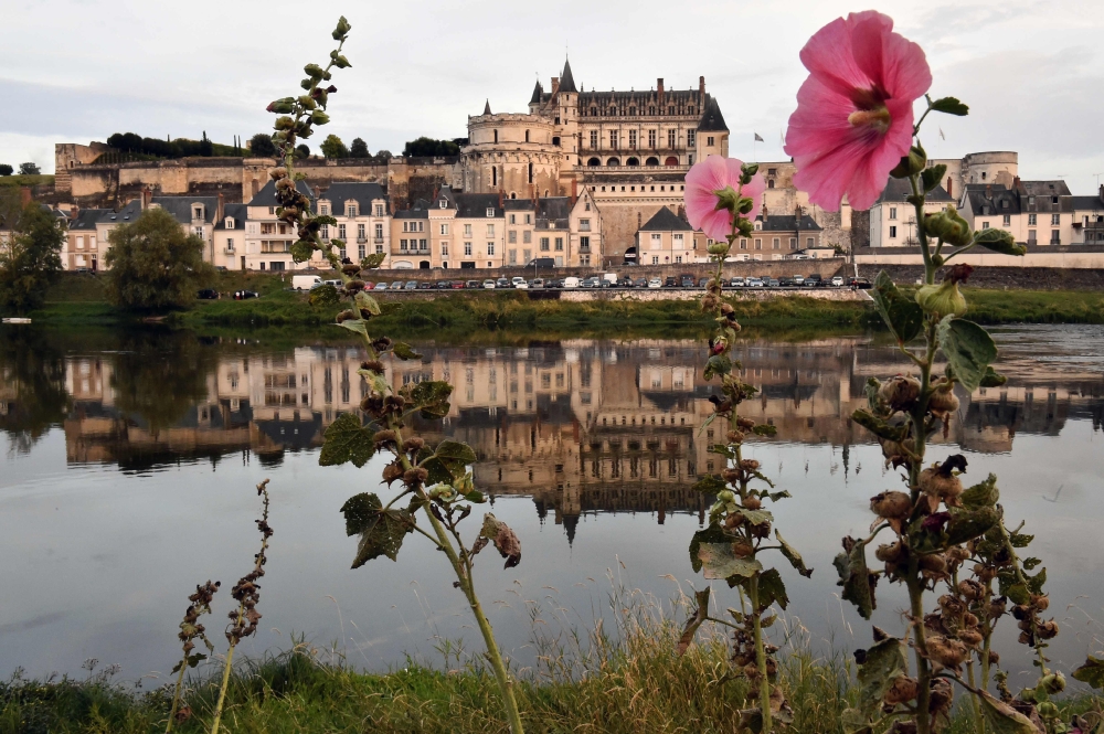 This photo taken on August 14, 2017 shows the Castle of Amboise reflected in the Loire river in Amboise, central France. AFP / Jean-Francois Monier 