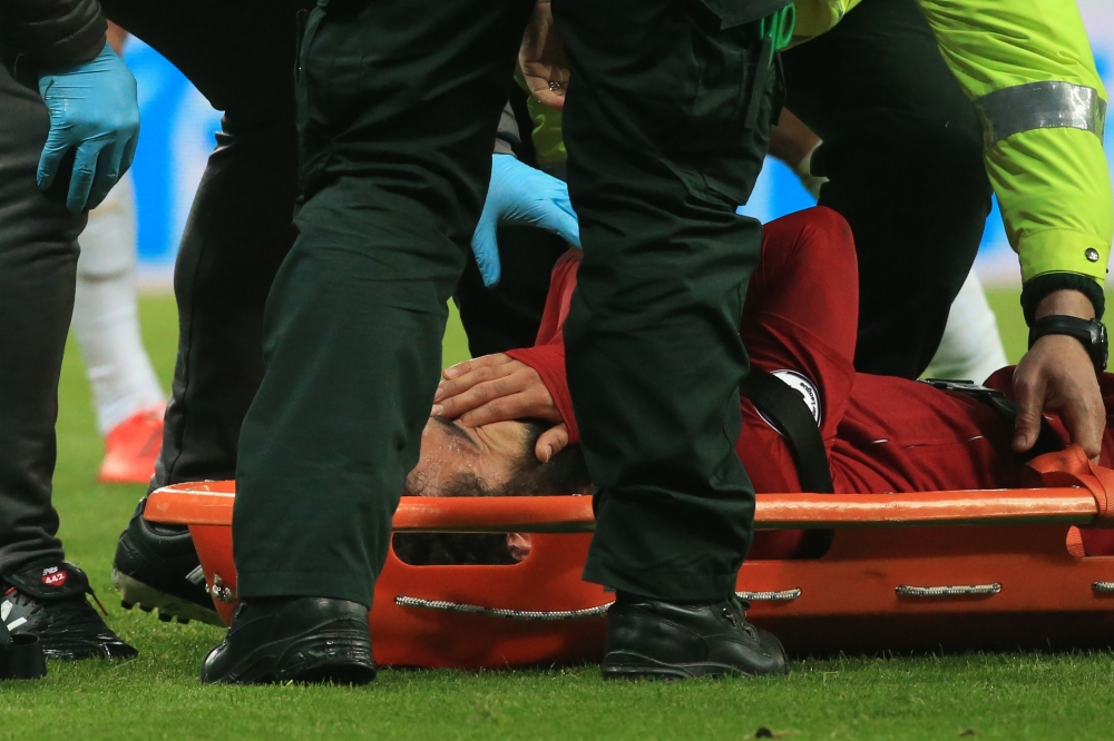 Liverpool's Egyptian midfielder Mohamed Salah reacts as he is placed on a stretcher after injuring himself in a challenge with Newcastle United's Slovakian goalkeeper Martin Dubravka (not pictured) during the English Premier League football match between 