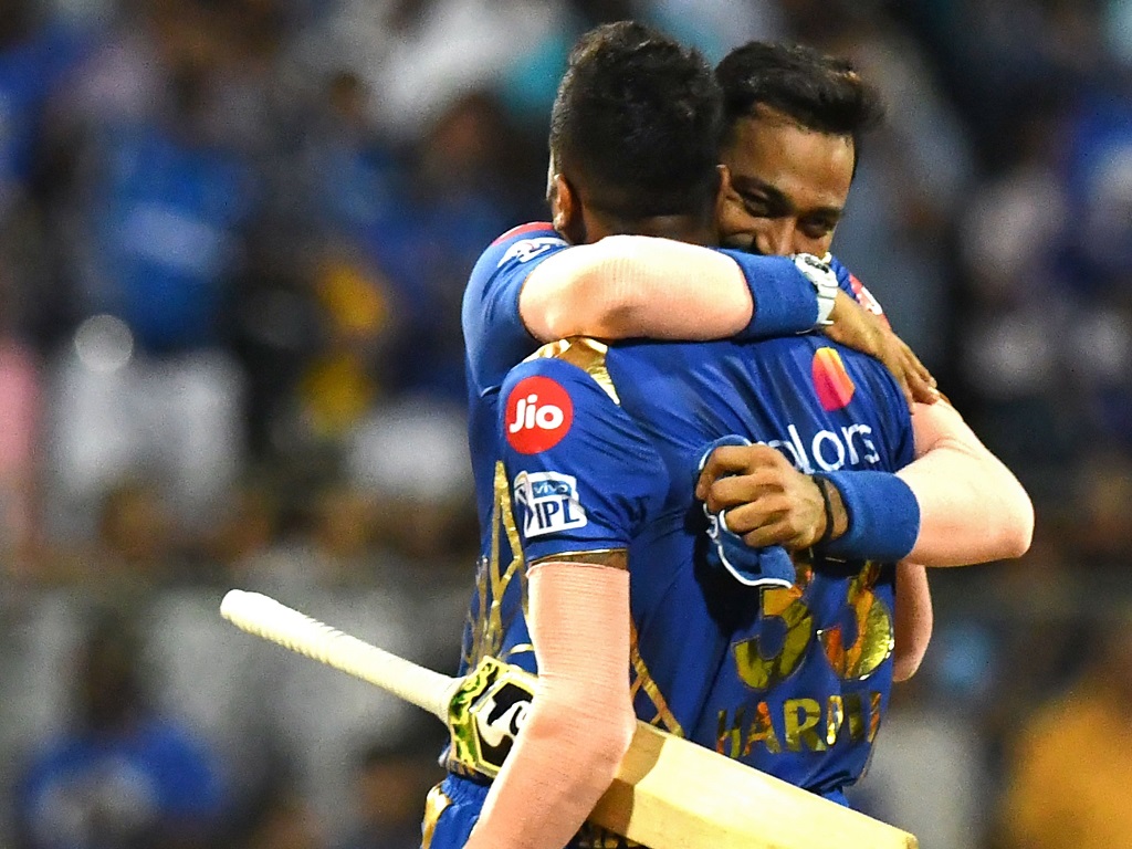 Mumbai Indians cricketer Krunal Pandya hugs his teammate and sibling Hardik Pandya after winning the 2019 Indian Premier League (IPL) Twenty20 cricket match between Mumbai Indians and Sunrisers Hyderabad at the Wankhede Stadium cricket stadium in Mumbai o