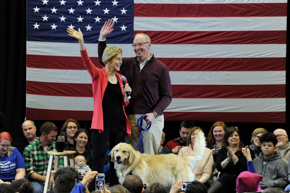
In this file photo taken on January 12, 2019 Senator Elizabeth Warren (D-MA), husband Bruce Mann and their dog Bailey take the stage before Warren addresses an “Organizing Event” as part of her exploratory presidential committee at Manchester Community 