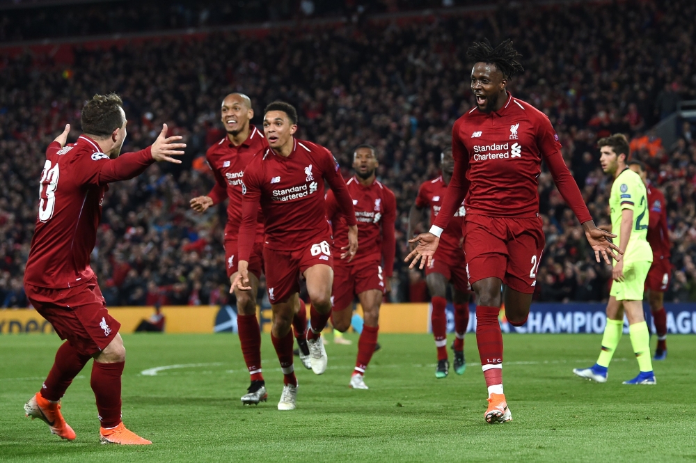 Liverpool's Belgian striker Divock Origi (R) celebrates after scoring their fourth goal during the UEFA Champions league semi-final second leg football match between Liverpool and Barcelona at Anfield in Liverpool, north west England on May 7, 2019. AFP /