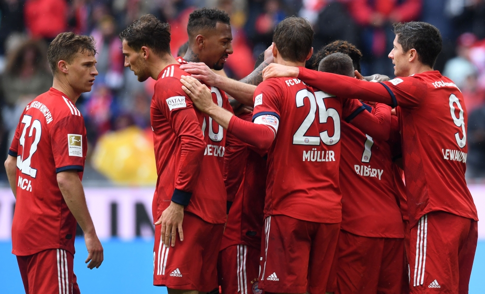 Several Bayern Munich players celebrate after the third goal for Munich during the German first division Bundesliga football match FC Bayern Munich vs Hanover 96 in the stadium in Munich, southern Germany, on May 4, 2019.   AFP / Christof STACHE