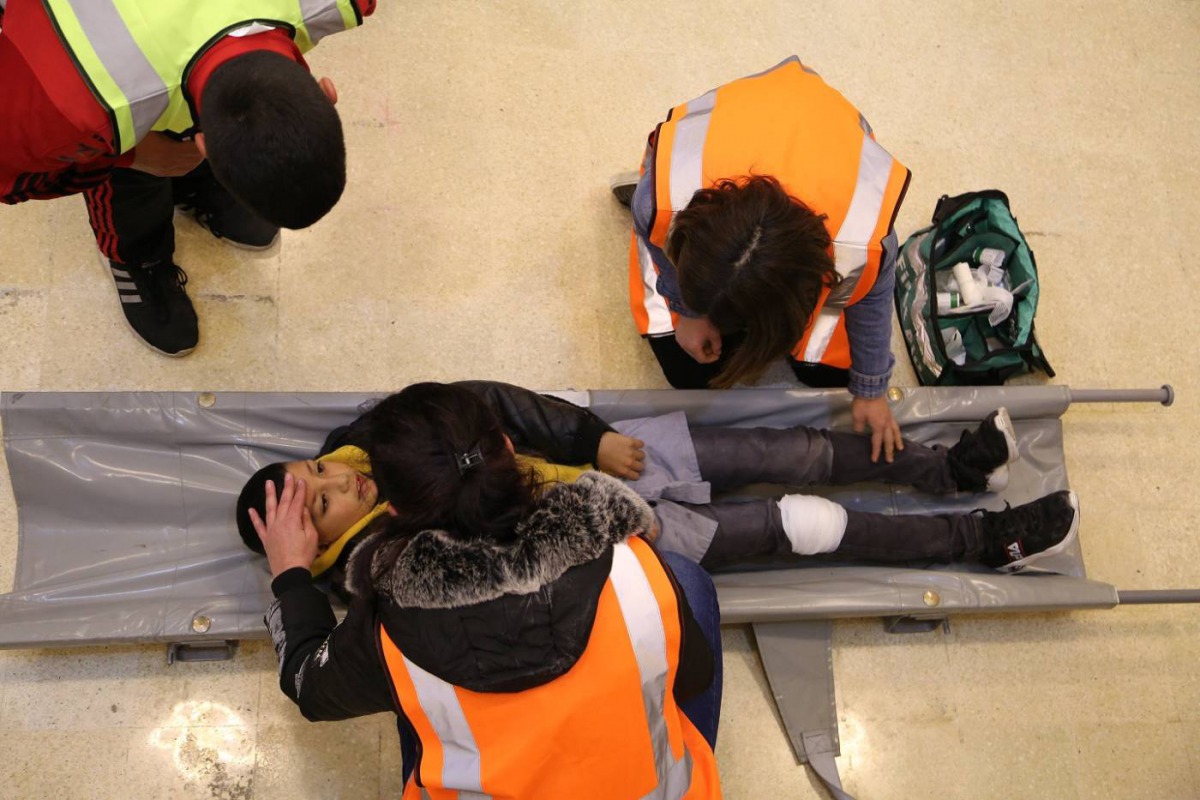 Volunteers conduct a first-aid check on a student during a safety drill at ATakmiliyat Al Kobba 2nd School in Tripoli, Lebanon, March 28, 2019. Thomson Reuters Foundation/Heba Kenso