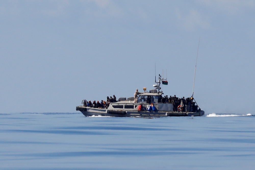 Migrants are seen onboard a Libyan Coast Guard vessel following a rescue operation in central Mediterranean Sea, January 31, 2018. Reuters/Alkis Konstantinidis