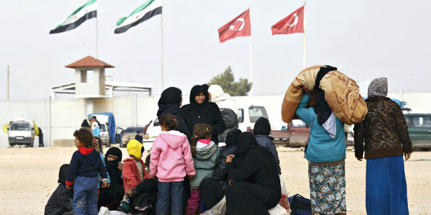 Internally displaced Syrians wait near the Bab al-Salam crossing, opposite the Turkey's Kilis province, on the outskirts of the northern Syrian border town of Azaz in this Reuters file photo