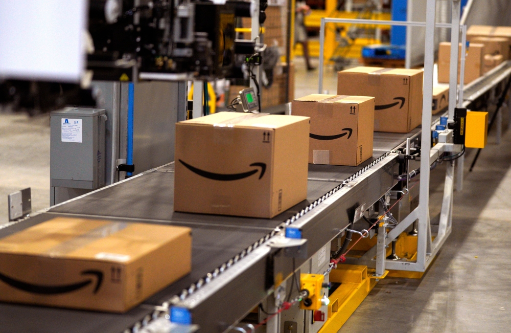 In this file photo, packed orders move down a converyor belt at the Amazon fullfillment center in Aurora, Colorado. (AFP / GETTY IMAGES NORTH AMERICA / Rick T. Wilking)