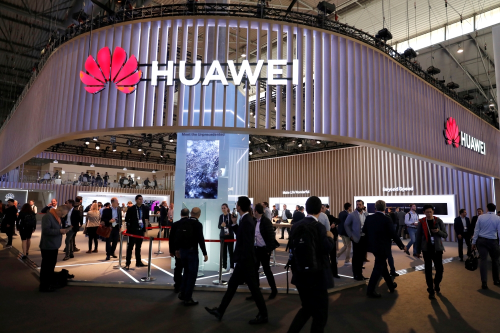 Visitors walk next to Huawei booth at the Mobile World Congress in Barcelona, February 27, 2019. Reuters/Rafael Marchante