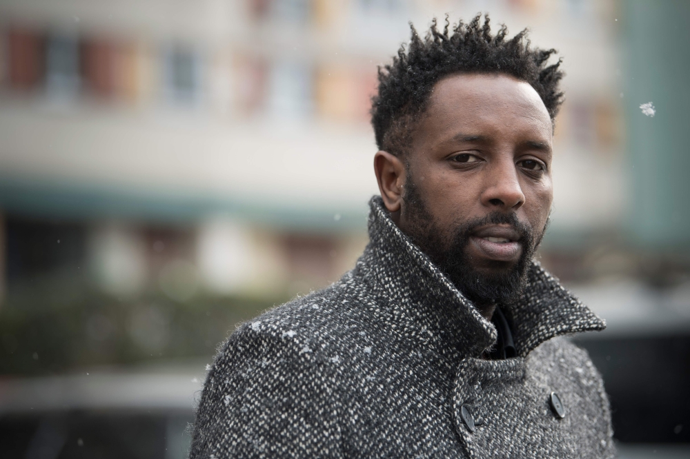 French director Ladj Ly poses under the snow on February 27, 2018 during a portrait session in the 