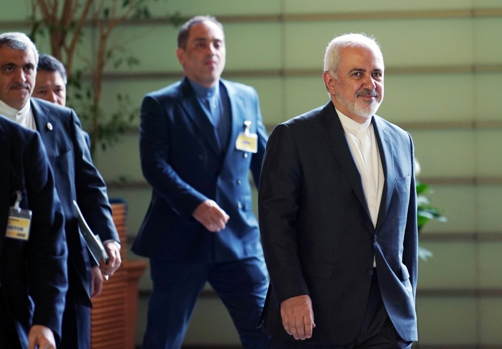Iranian Foreign Minister Mohammad Javad Zarif, right, walks to meet Japanese Prime Minister Shinzo Abe at Abe's official residence in Tokyo Thursday, May 16, 2019. Eugene Hoshiko/Pool via REUTERS