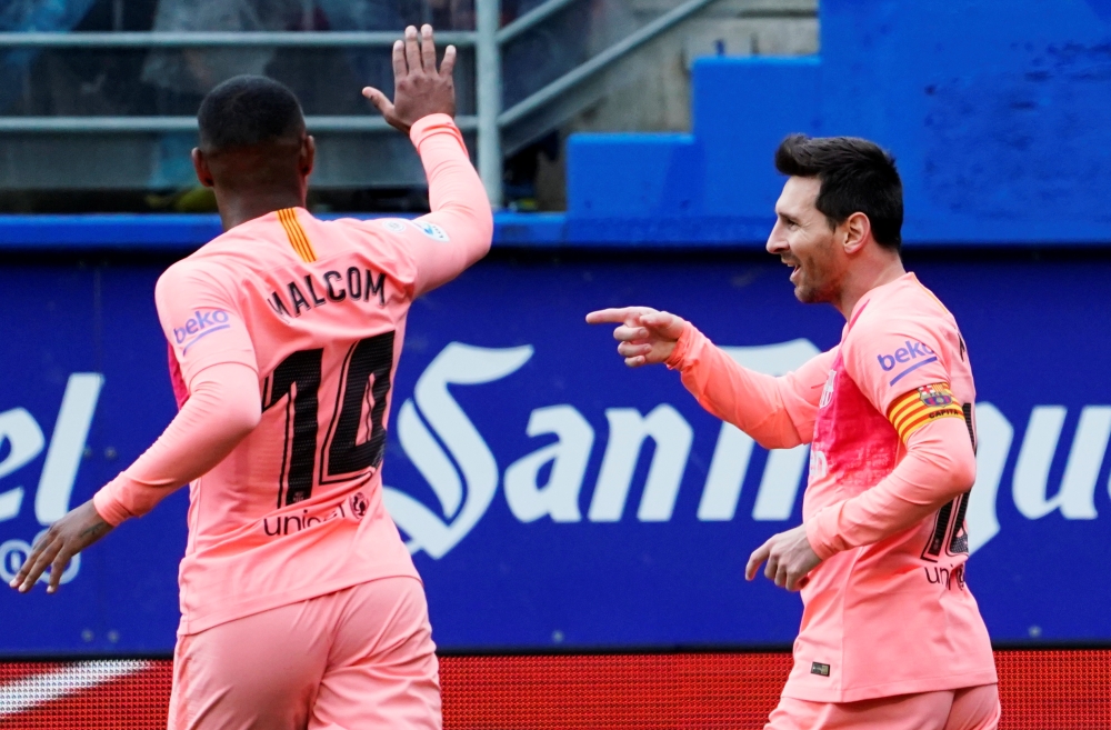 Barcelona's Lionel Messi celebrates scoring their first goal with Malcom REUTERS/Vincent West
