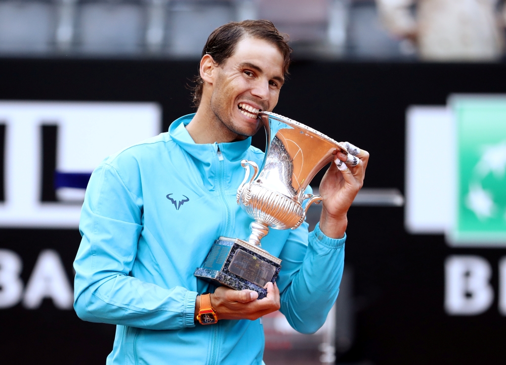 Spain's Rafael Nadal poses as he celebrates winning the final against Serbia's Novak Djokovic with the trophy REUTERS/Matteo Ciambelli