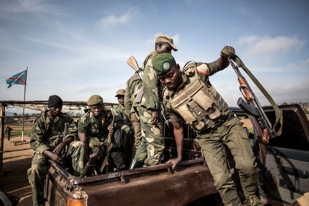 Soldiers of the Armed Forces of the Democratic Republic of the Congo (FARDC) prepare to escort health workers attached to ebola response programs on May 18, 2019 in Butembo, north of Kivu.  AFP / John Wessels .

