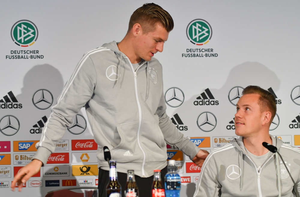 FILE PHOTO: Marc-Andre Ter Stegen (R), goalkeeper of the German national football team, and the team's midfielder Toni Kroos attend a press conference on the eve of the team's international friendly match against Spain in Duesseldorf, western Germany. AFP