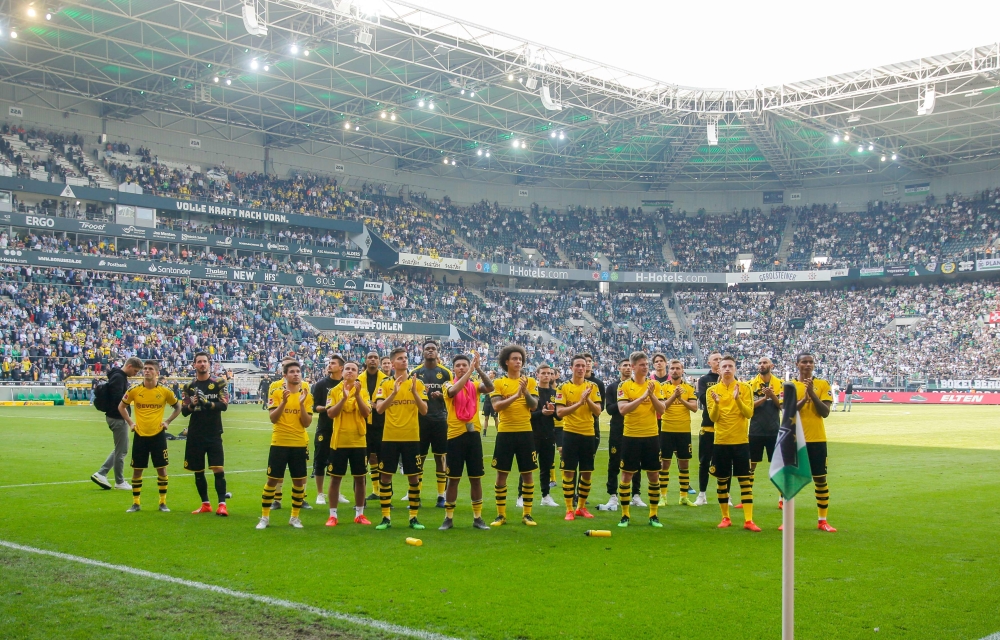 Dortmund players cheer to their supporters after the German First division Bundesliga football match BVB Borussia Moenchengladbach v Borussia Dortmund in Moenchengladbach, western Germany, on May 18, 2019. AFP / LEON KUEGELER 