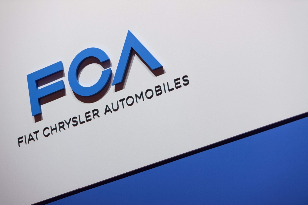 FILE PHOTO: A FCA (Fiat Chrysler Automobiles) logo is displayed on March 6, 2019 during a press day ahead of the Geneva International Motor Show in Geneva.  AFP / Harold CUNNINGHAM
