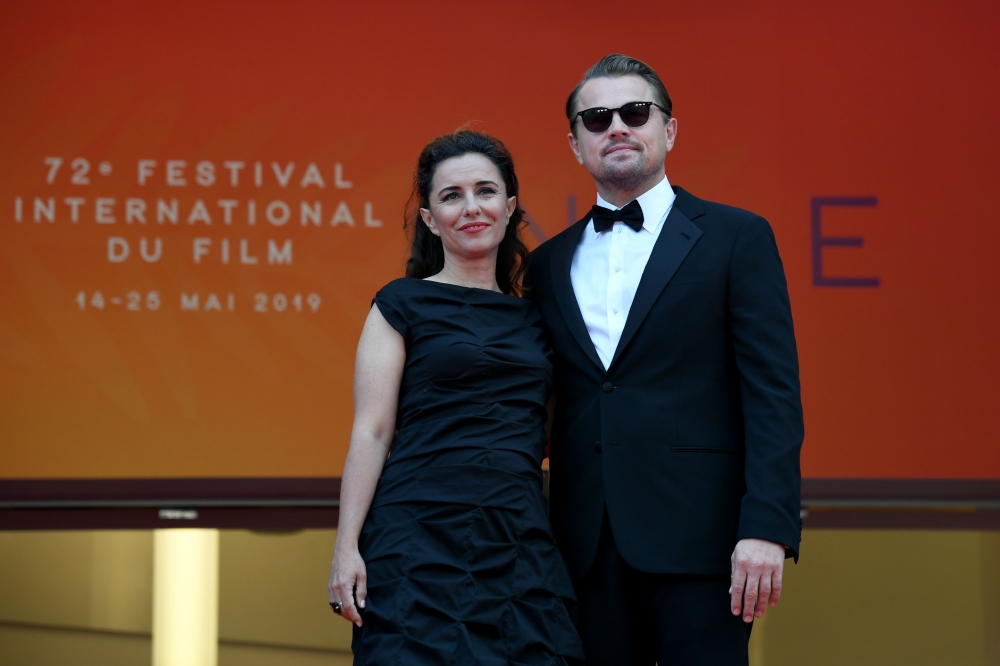 US actor Leonardo DiCaprio (R) and US director Leila Conners pose as they arrive for the screening of the film 