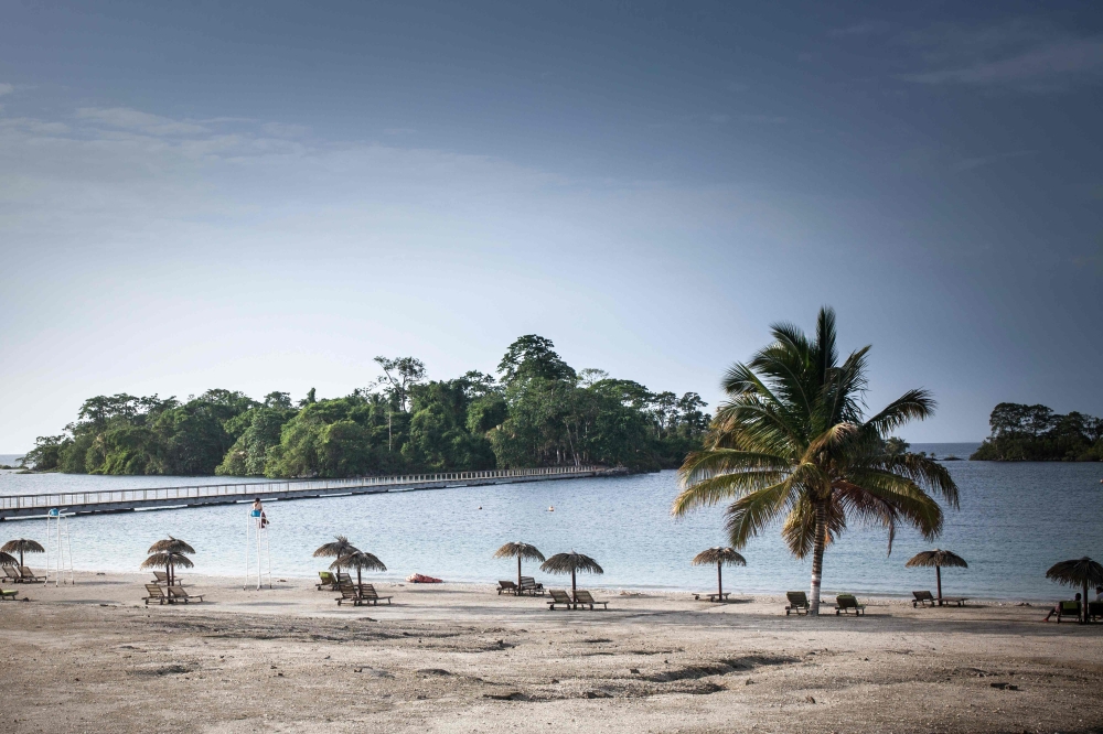 A person sits on a chair on the artificial beach of the Sofitel Hotel, in Sipopo, nearly 16km from Malabo in Equatorial Guinea, on April 20, 2019. AFP / Camille Malplat  
