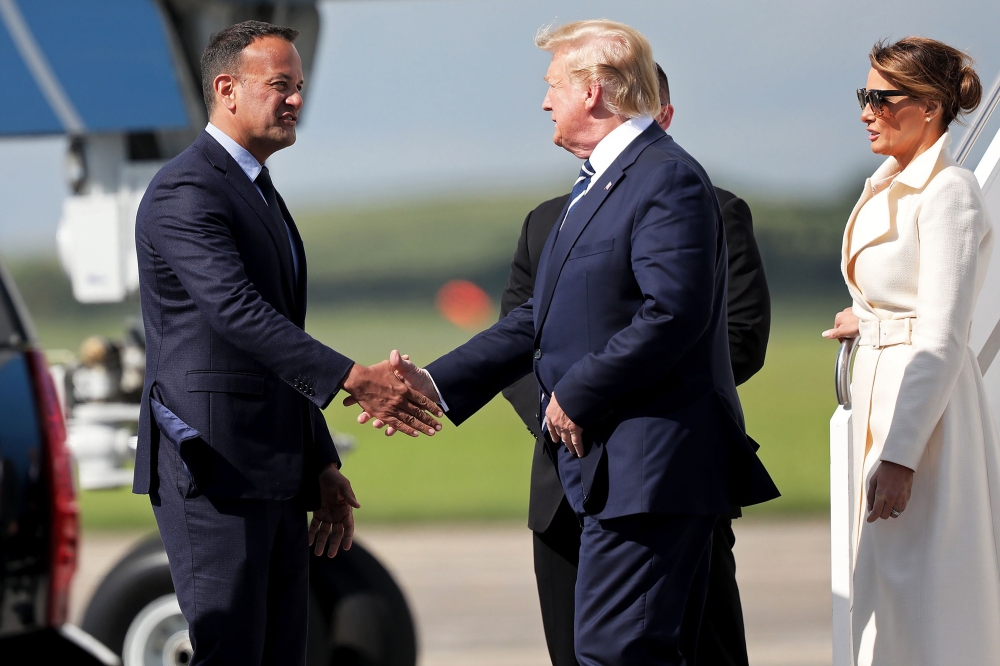US President Donald Trump (C) being greeted by Irish Prime Minsiter Leo Varadkar (L) upon disembarking Air Force One upon arrival at Shannon Airport, Ireland on June 5, 2019. AFP/ Irish Government