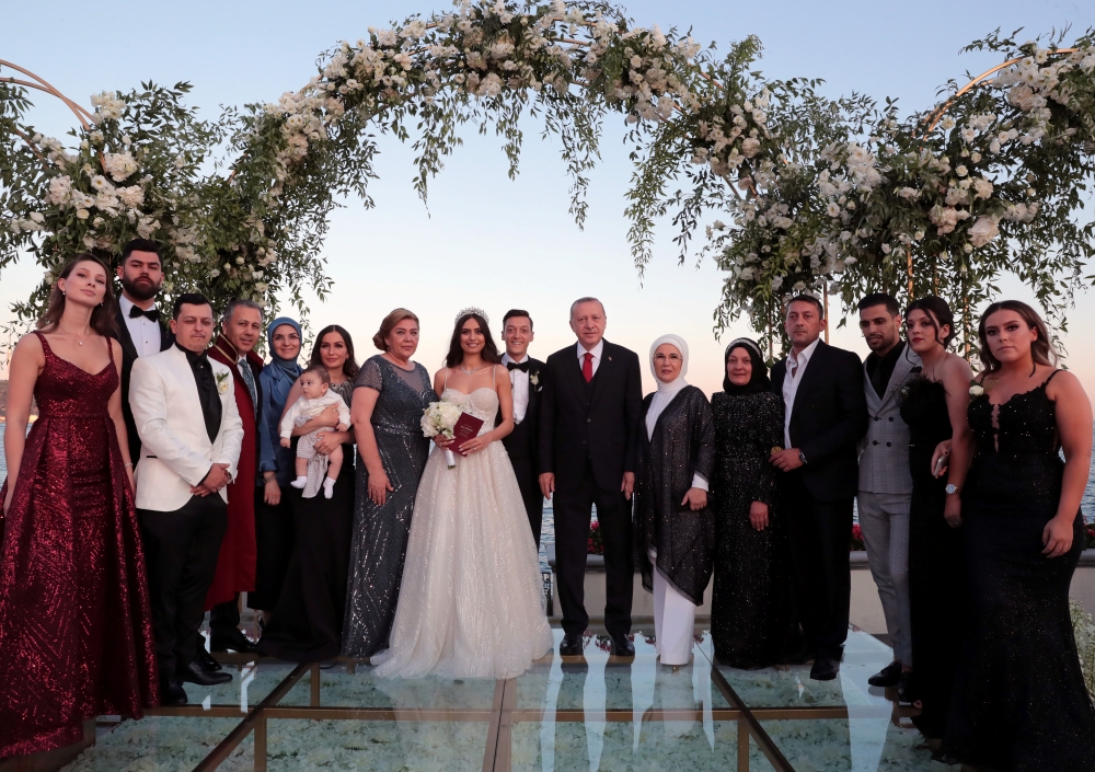 Turkish President Tayyip Erdogan and his wife Emine Erdogan pose with Arsenal's German soccer player Mesut Ozil, who is of Turkish descent, and his fiancee Amina Gulse during their wedding ceremony in Istanbul, Turkey, June 7, 2019. Murat Cetinmuhurdar/Pr