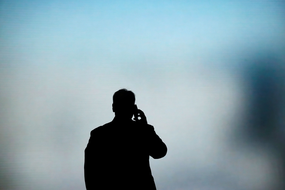 A man talks on his phone at the Mobile World Congress in Barcelona on February 27, 2019, AFP/Pau Barrena