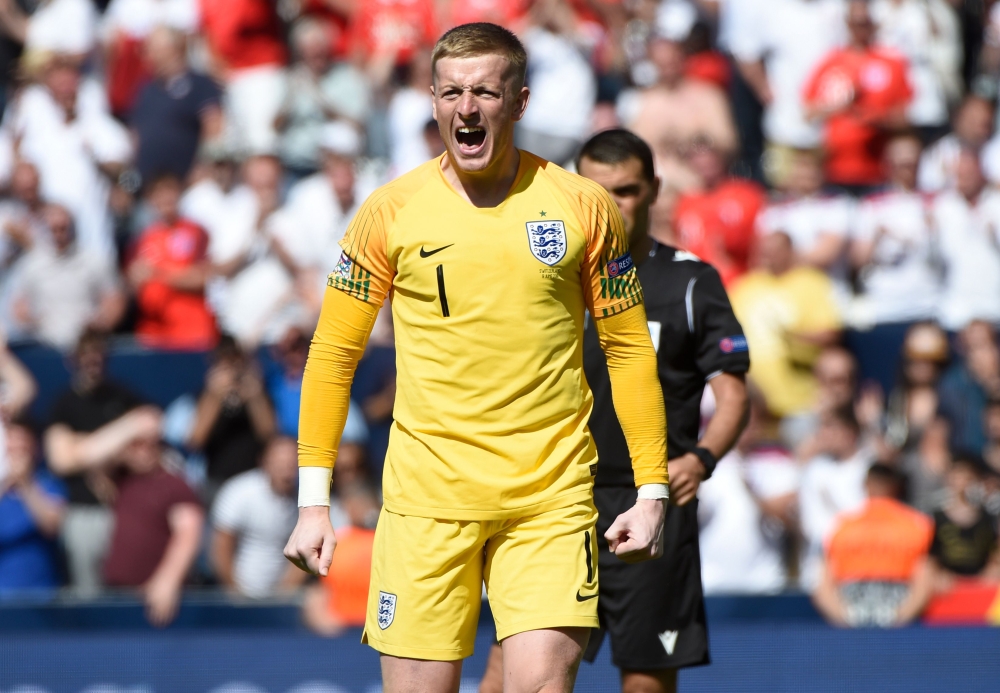 England's goalkeeper Jordan Pickford celebrates a goal during the penalty shootout during the UEFA Nations League third place football match between England and Switzerland at the D.Afonso Henriques stadium in Guimaraes, on June 9, 2019 / AFP / MIGUEL RIO