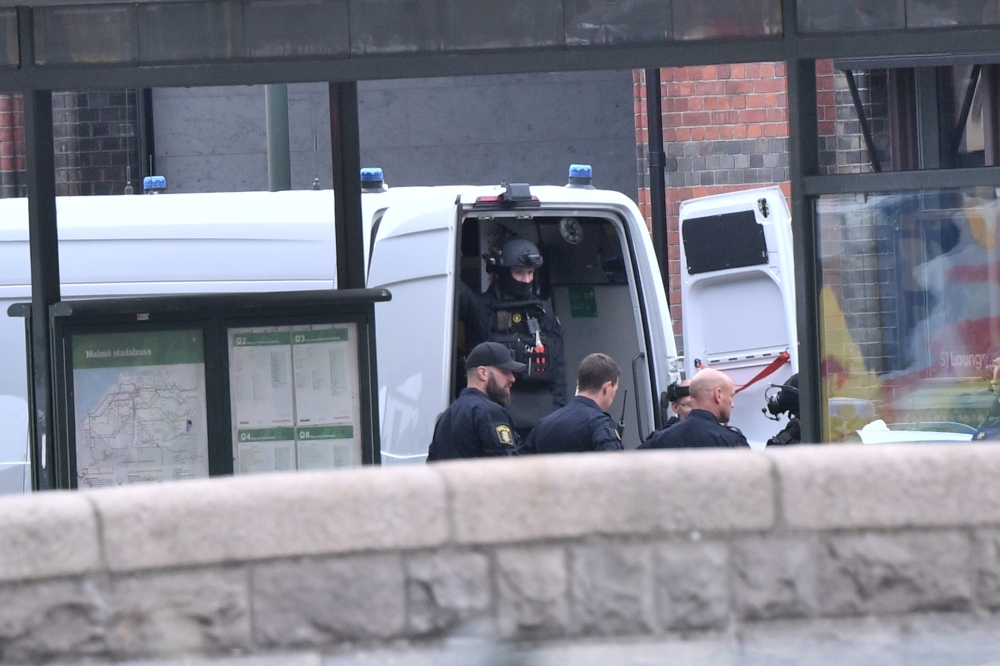 Police members are seen at Malmo central station after shooting a man for 