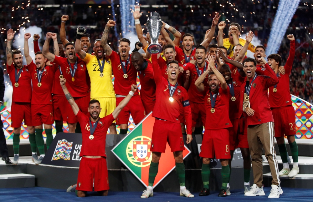 Portugal's Cristiano Ronaldo and team mates celebrate winning the UEFA Nations League Final with the trophy Action Images via Reuters/Carl Recine