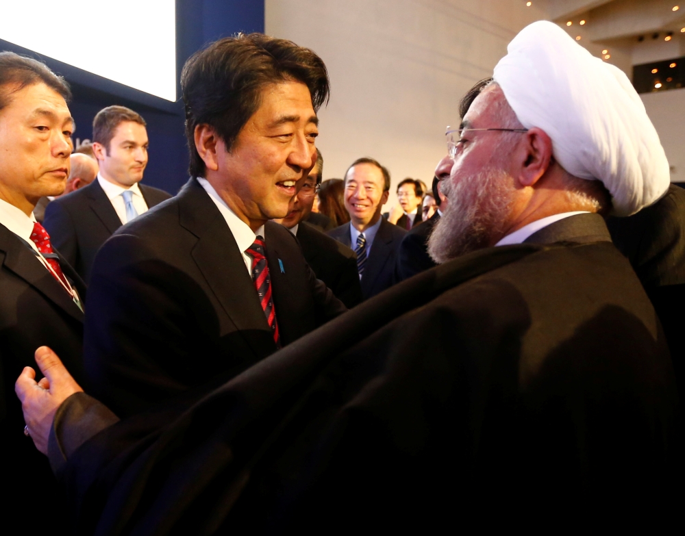 FILE PHOTO: Japan's Prime Minister Shinzo Abe greets Iran's President Hassan Rouhani (R) during the annual meeting of the World Economic Forum (WEF) in Davos January 22, 2014. REUTERS/Denis Balibouse/File Photo