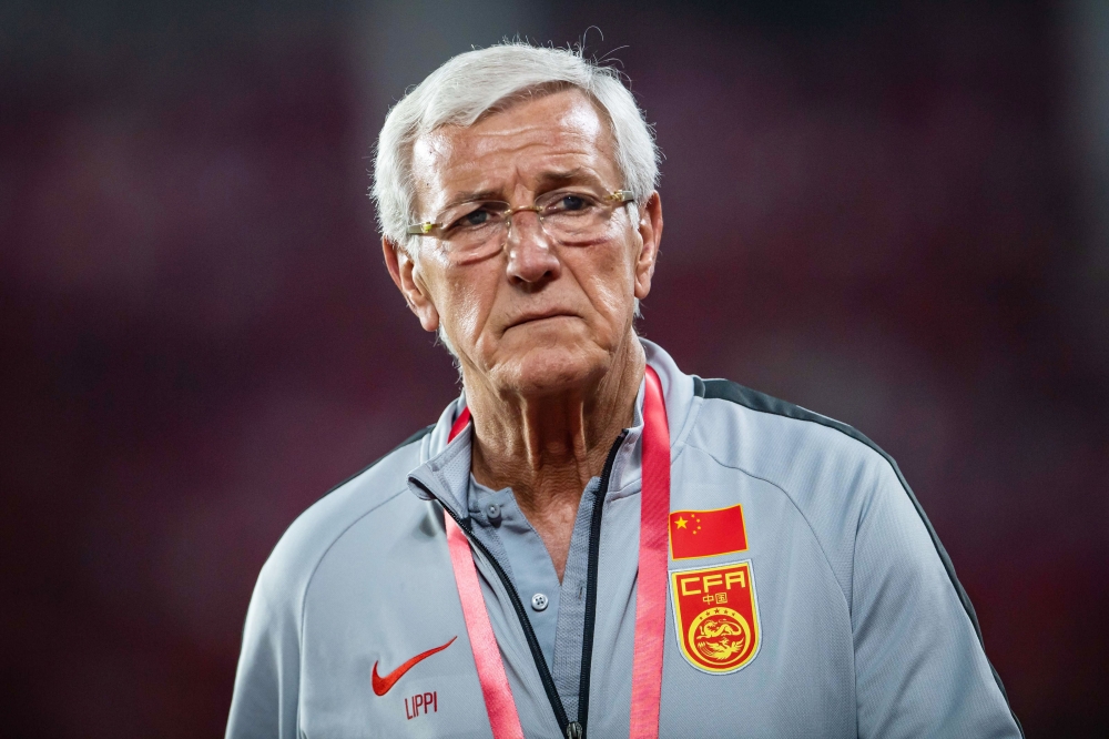 China's coach Marcello Lippi looks on during China's football friendly match against Tajikistan in Guangzhou, in China's southern Guangdong province on June 11, 2019. China OUT / AFP 