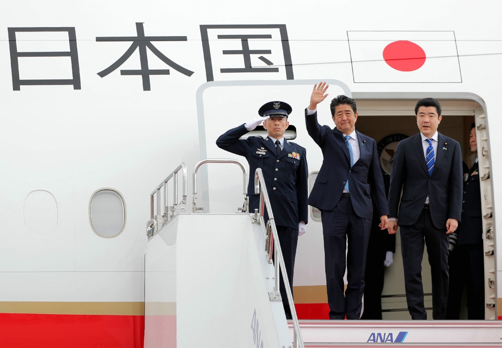 Japan's Prime Minister Shinzo Abe (C) waves to well-wishers upon his departure at Tokyo's Haneda Airport on June 12, 2019. Abe left for a two-day visit to Iran. - Japan / AFP / JIJI PRESS / JIJI PRESS