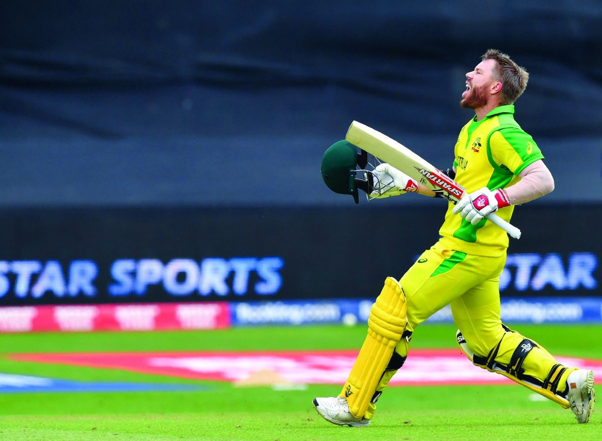 Australia's David Warner celebrates after scoring a century (100 runs) during the 2019 Cricket World Cup group stage match between Australia and Pakistan at The County Ground in Taunton, southwest England, on June 12, 2019.  AFP / Saeed Khan 